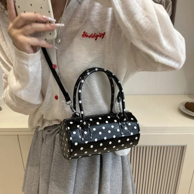 Korean-style cylindrical tote pillow bag in PU leather with stitched seams, black colour, single strap