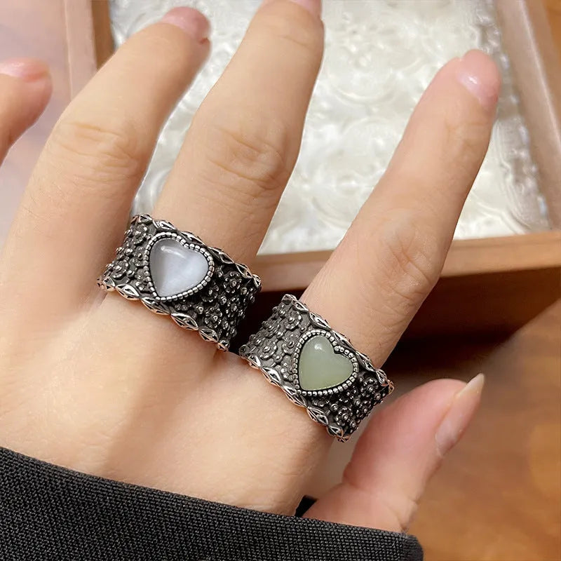 Retro wide-faced heart-shaped ring with adjustable opening in silver finish.