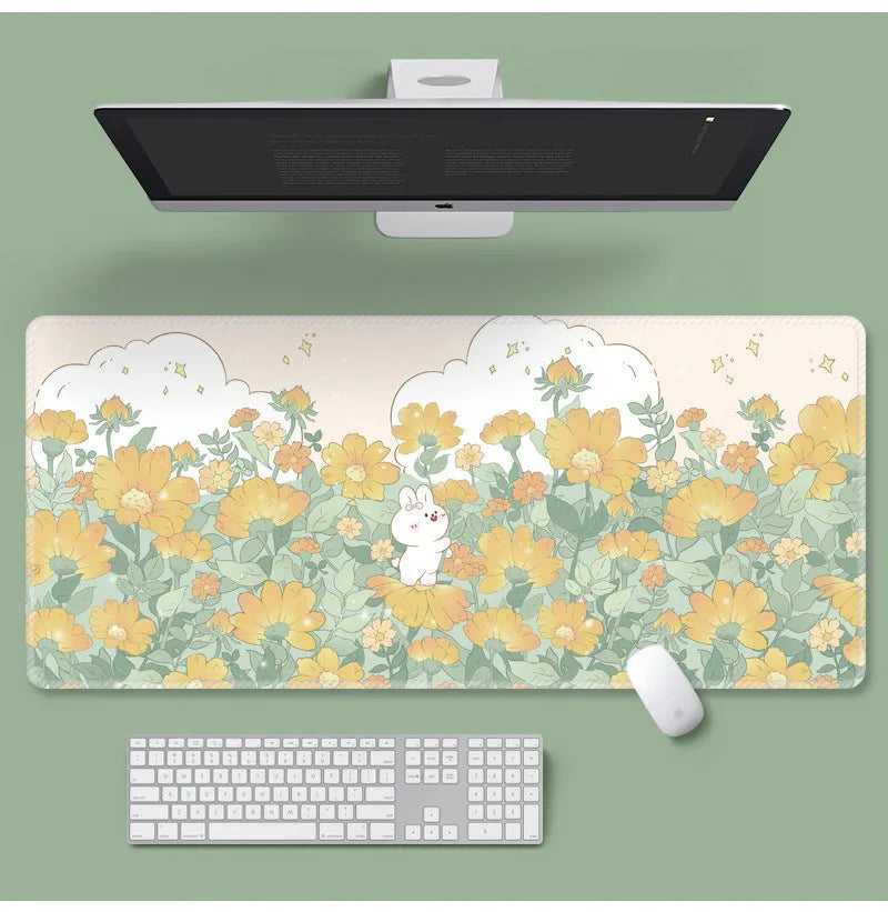 Large colourful cartoon flower pattern mouse pad on a desk with keyboard.
