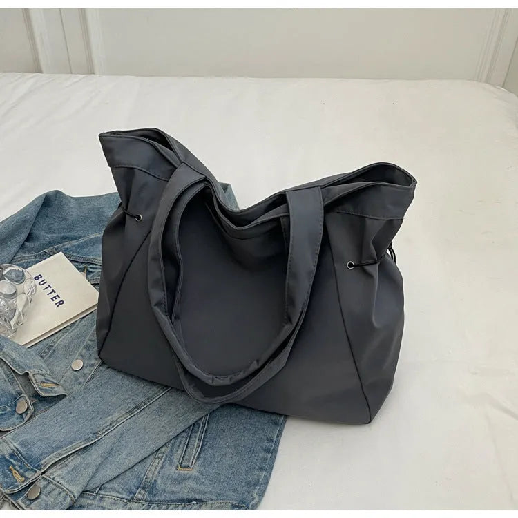 Oxford cloth shoulder tote bag in folding design showing soft construction and shoulder strap