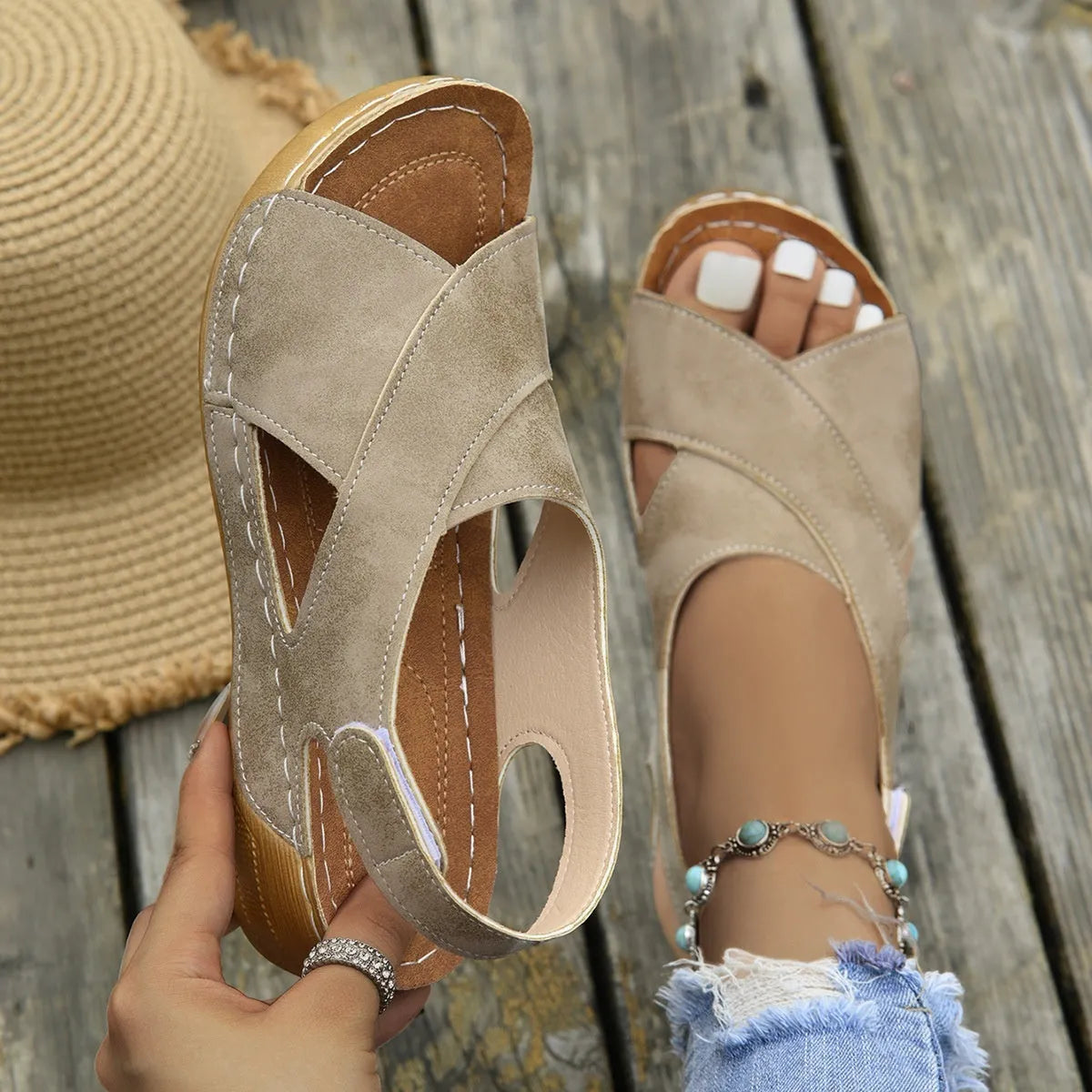 Brown Roman platform sandals with open toe and Velcro strap on a white background.