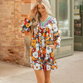 Orange floral print mini dress with striped lace on the V neckline and long sleeves.