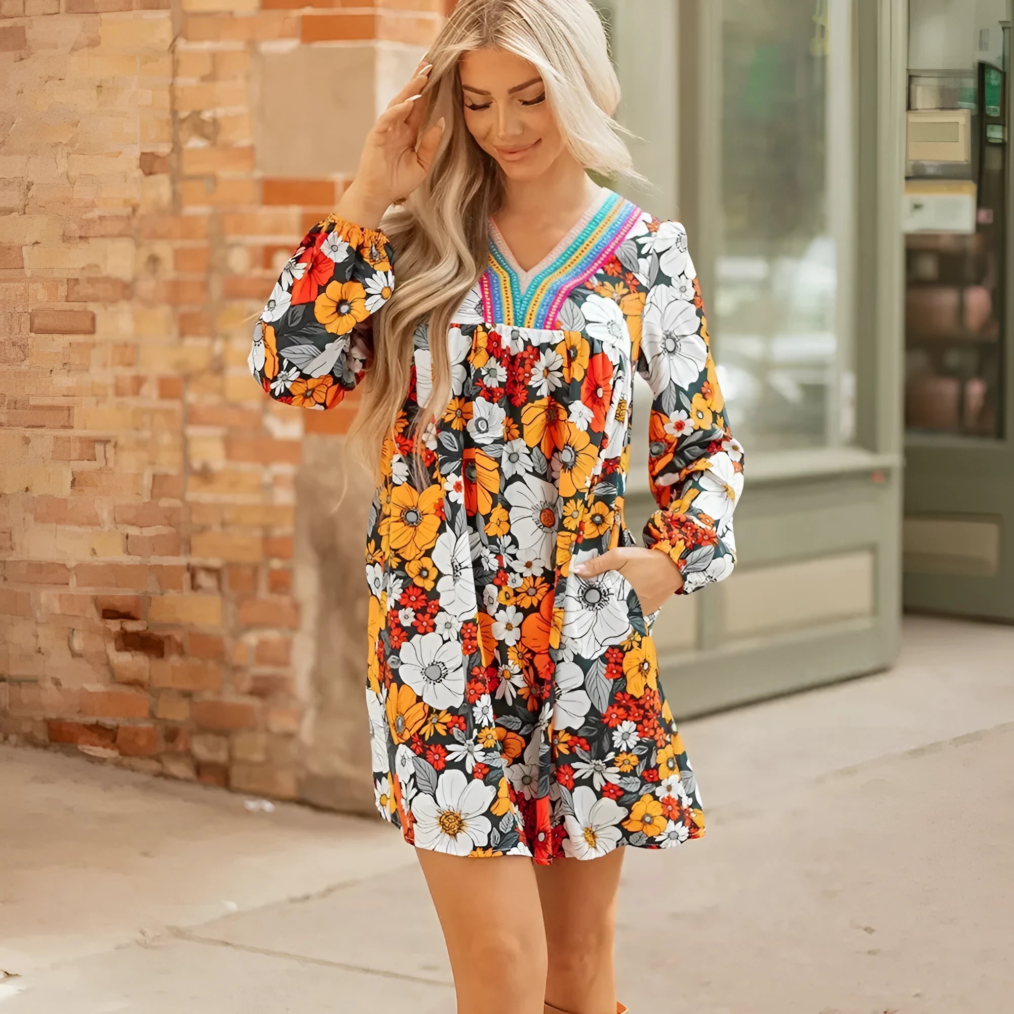 Orange floral print mini dress with striped lace on the V neckline and long sleeves.