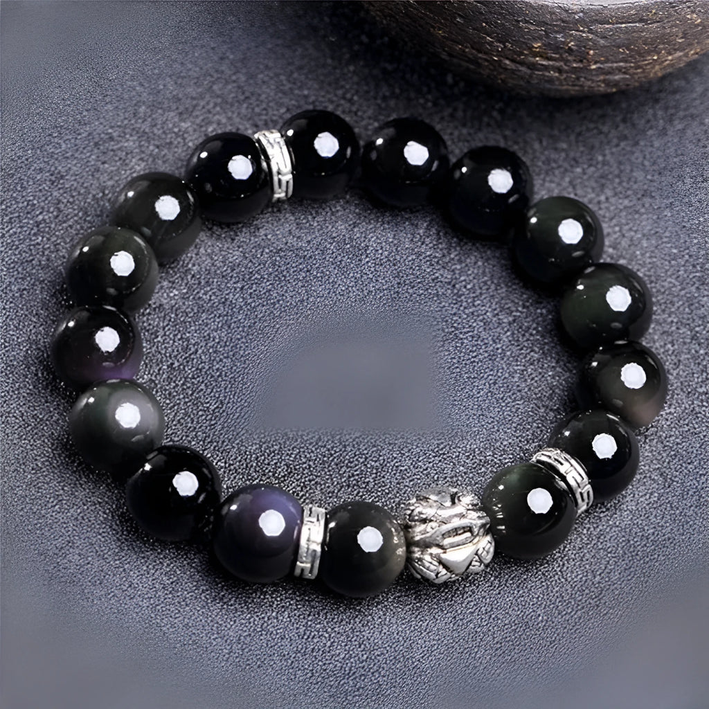 Natural obsidian and Silver 999 Cloud Year bracelet in simple unisex style on wrist.