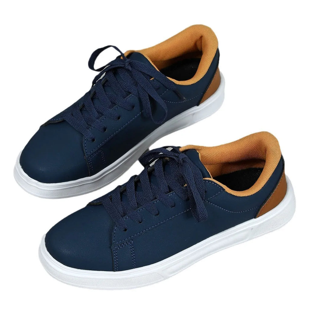 Beige brown casual platform sneakers with a cross strap and round toe on a rubber sole.