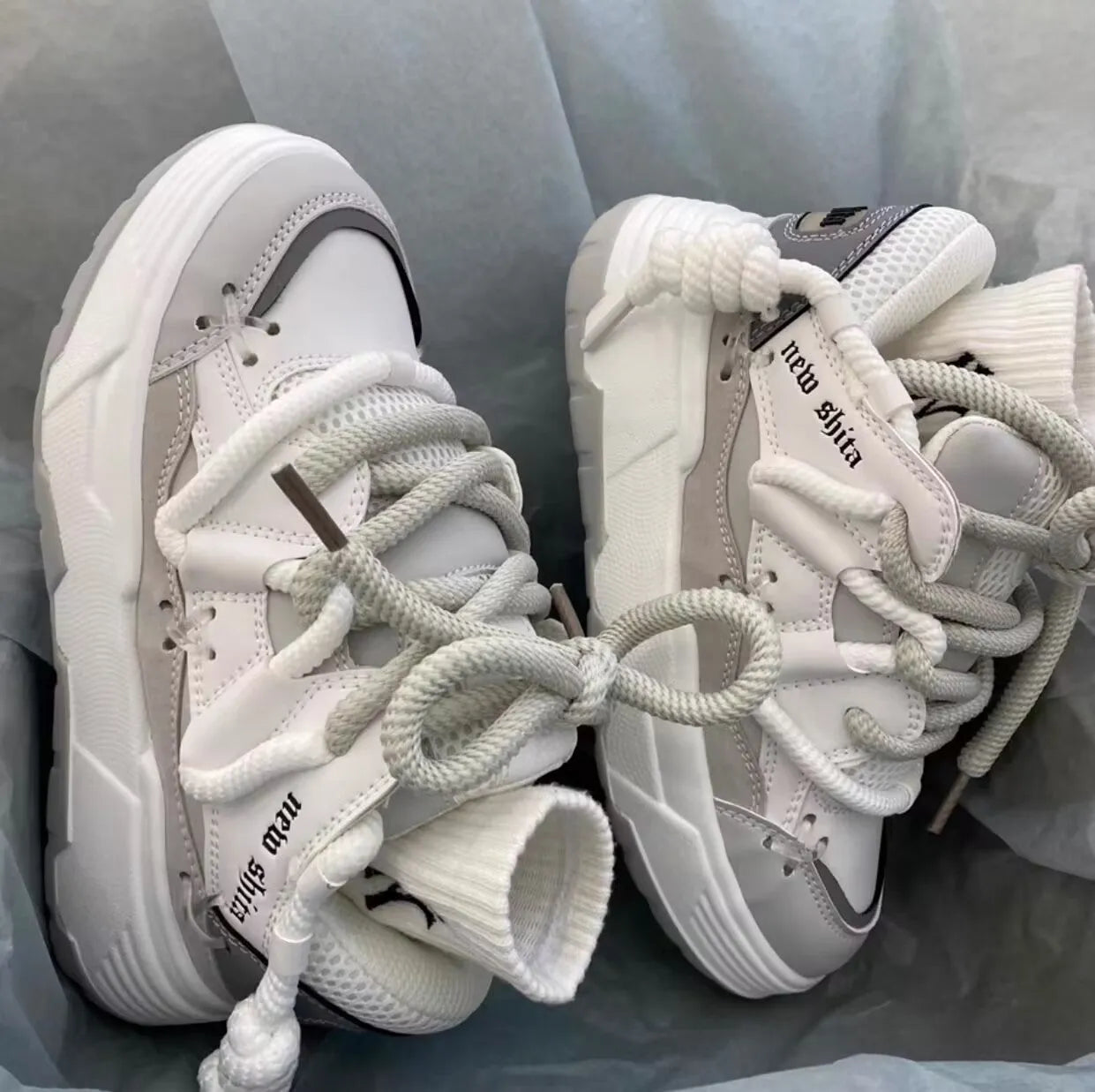 Women's grey retro chunky sneakers with a thick rubber sole and flat 6-8 cm heel.