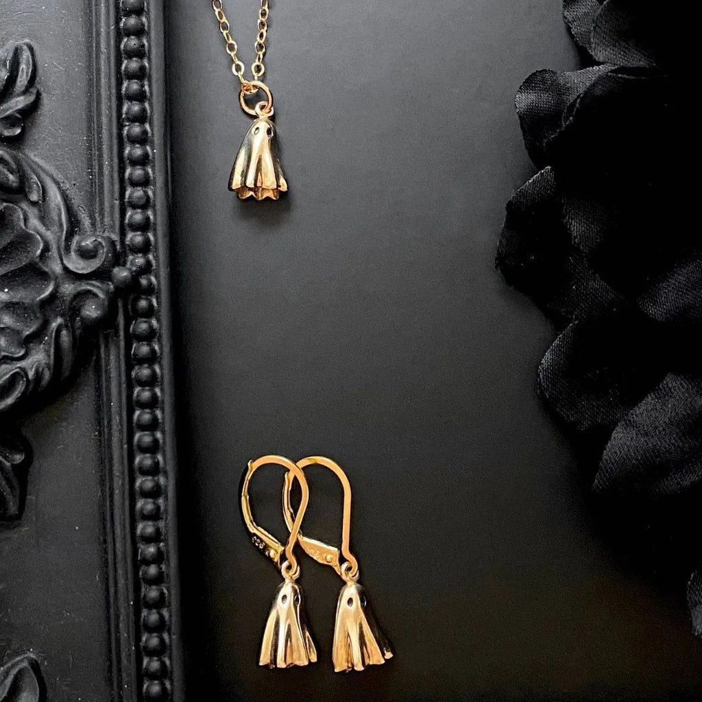 A ghost-themed pendant necklace on a twisted stainless steel chain, showing the titanium steel pendant detail.