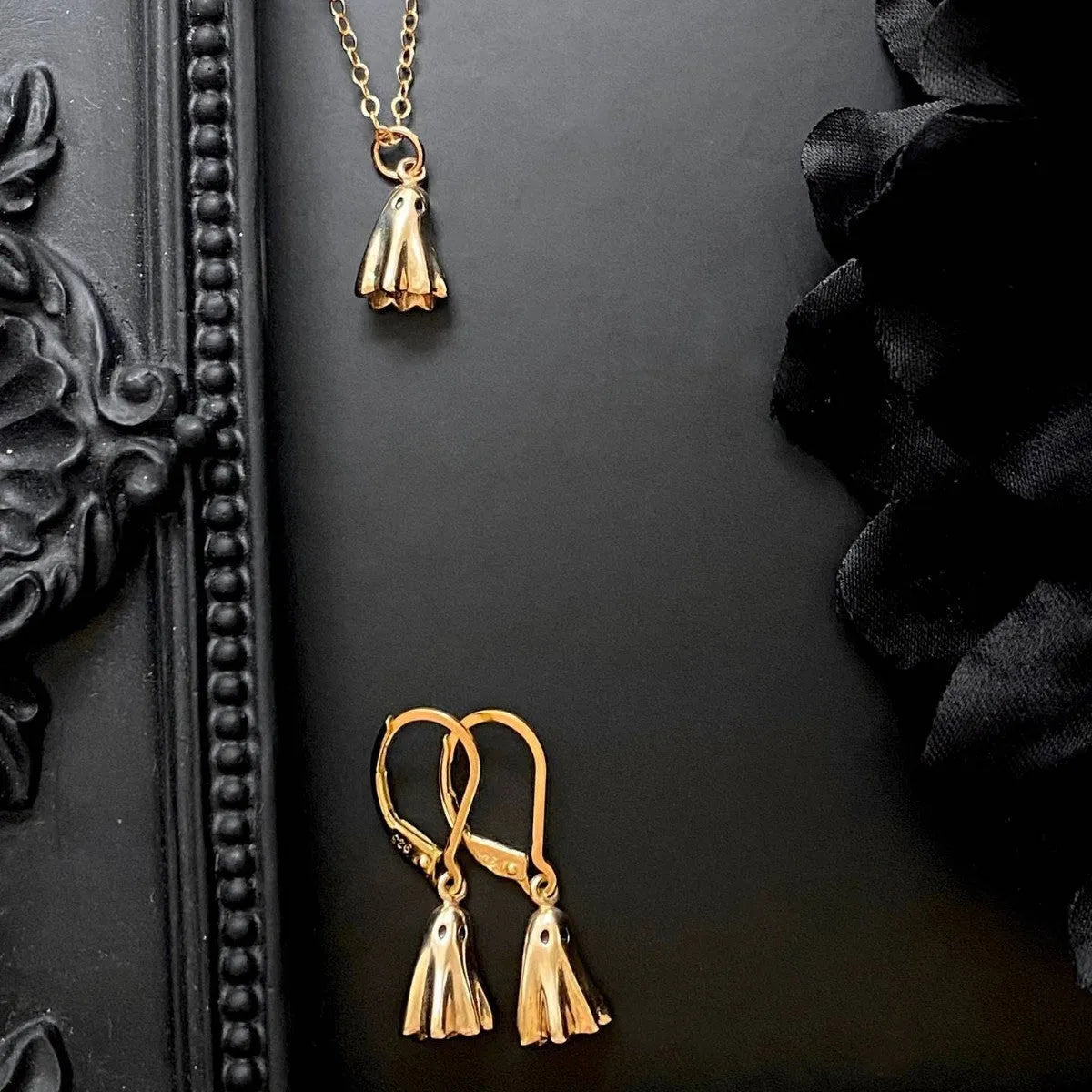 A ghost-themed pendant necklace on a twisted stainless steel chain, showing the titanium steel pendant detail.