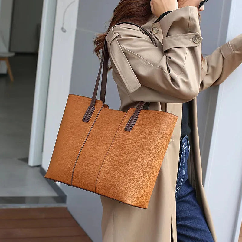 Women's black genuine leather crossbody commuter bag with square shape and multiple internal pockets.