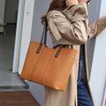 Women's black genuine leather crossbody commuter bag with square shape and multiple internal pockets.