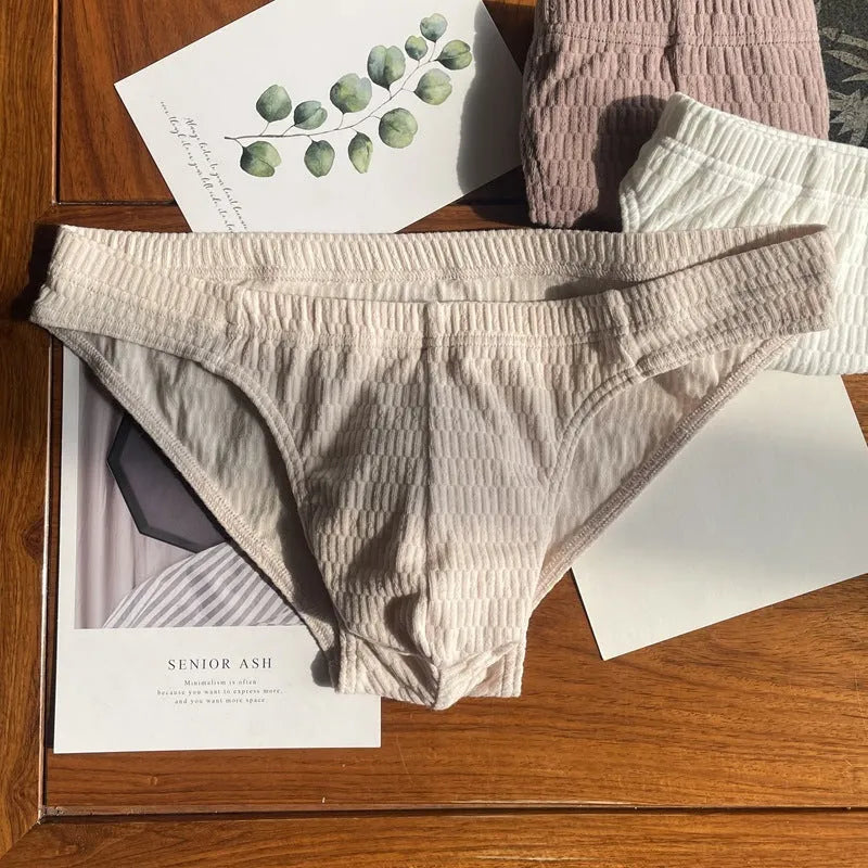 Men's solid colour cotton triangle underwear briefs with a mid waist design.