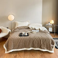 Polyester thermal flannel blanket in tea green colour on a bed, showing modern simplicity design.