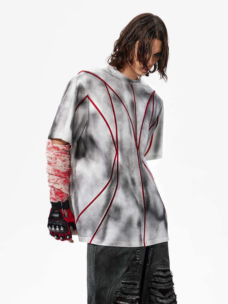 Men's grey T-shirt with padded shoulders and raised line patchwork detailing on the front.