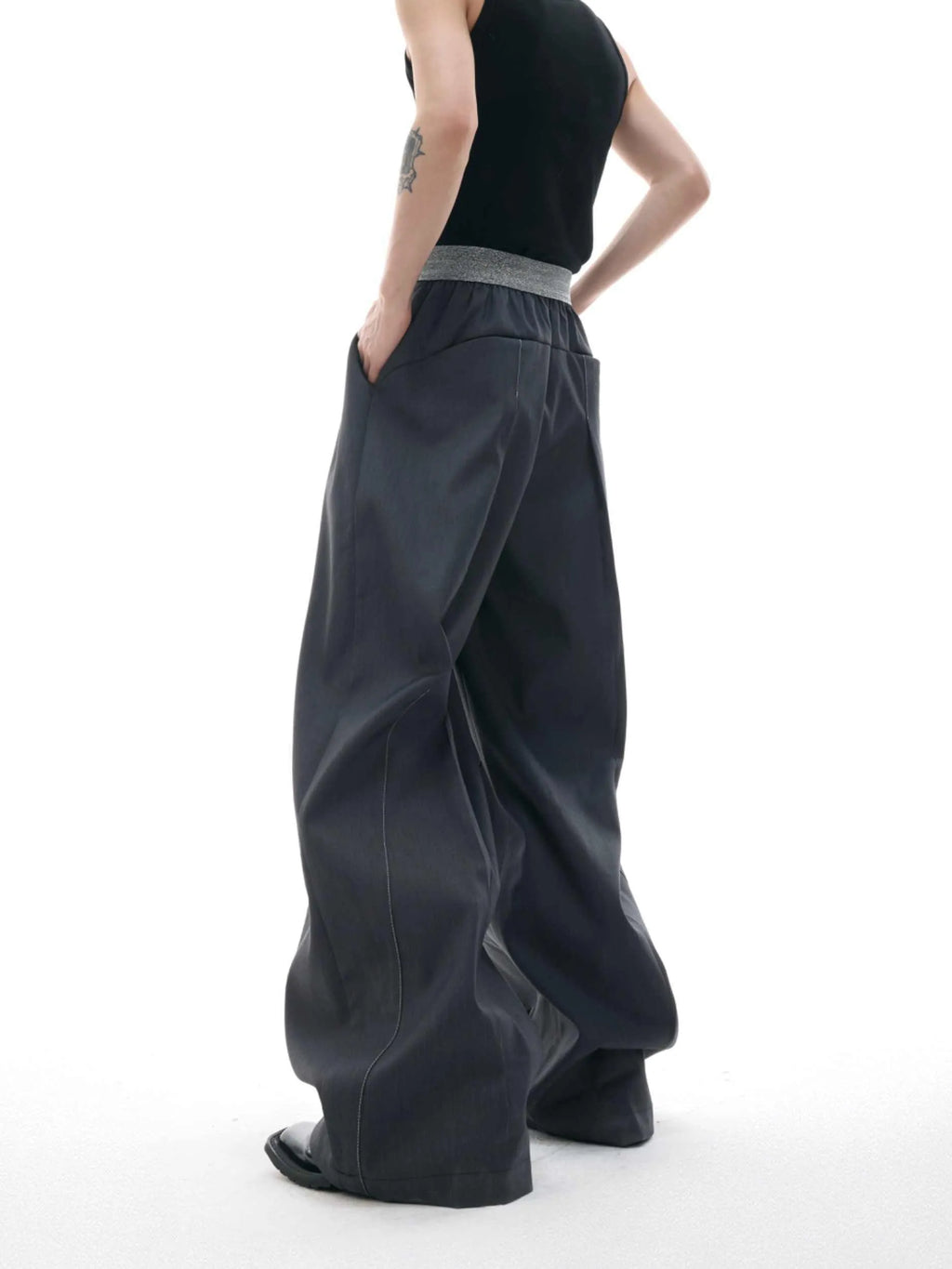 High-waisted drooping straight-leg trousers in black with button open line design detail.