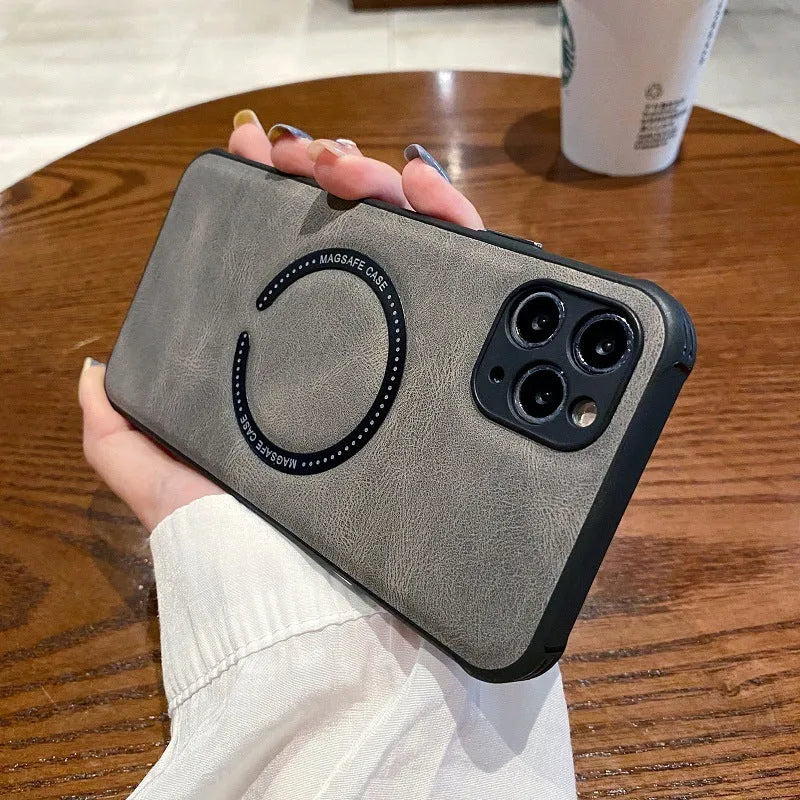 Black imitation leather magnetic charging case for iPhone on a table.