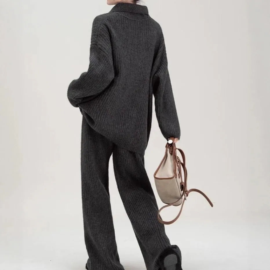 Beige acrylic imitation cashmere knitted top and trouser two-piece set on a hanger.