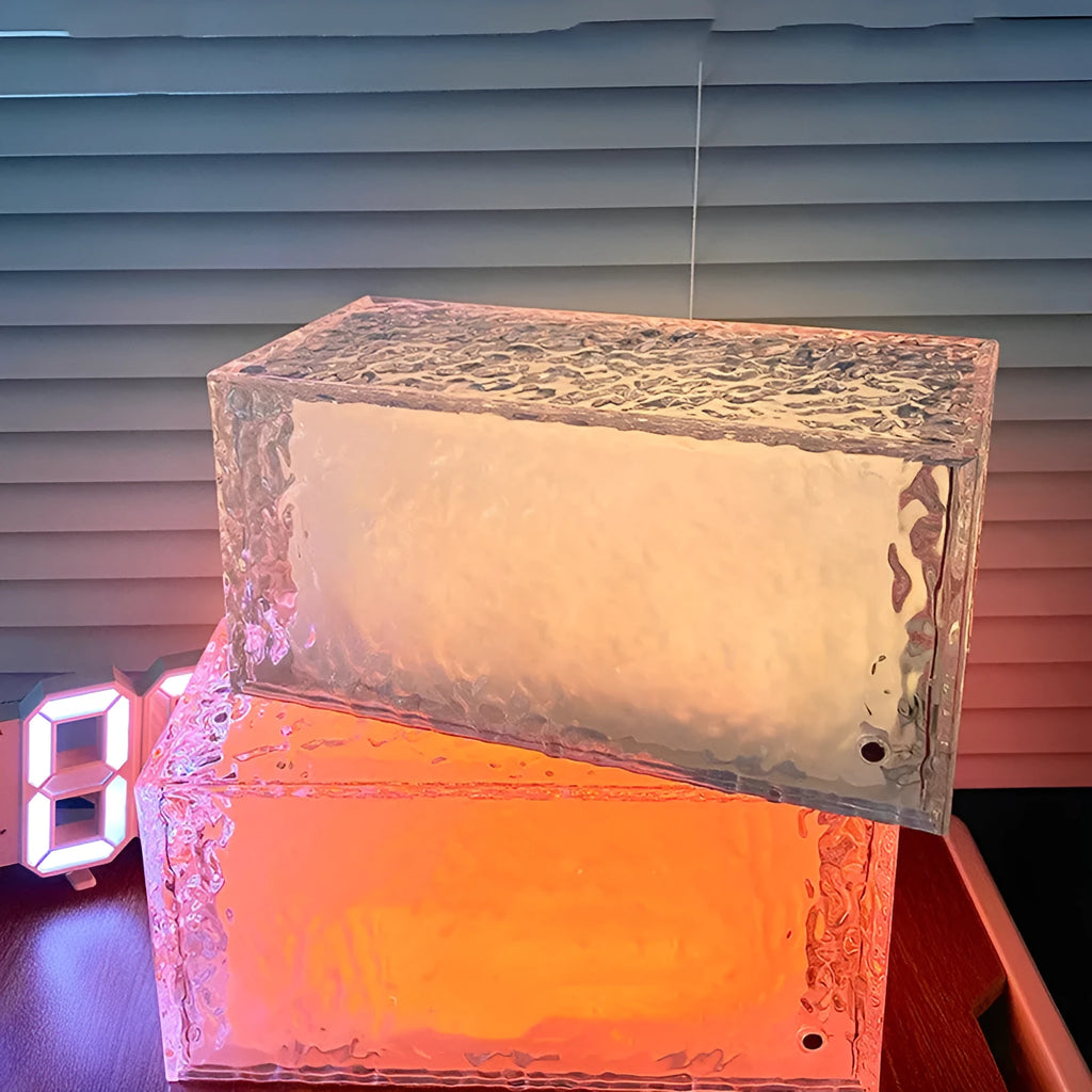 Geometric acrylic ice cube night lamp with colour changing LED lights on dark surface