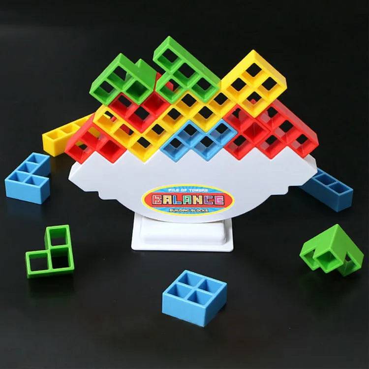 Plastic balance stacking game with coloured blocks on chassis for family play