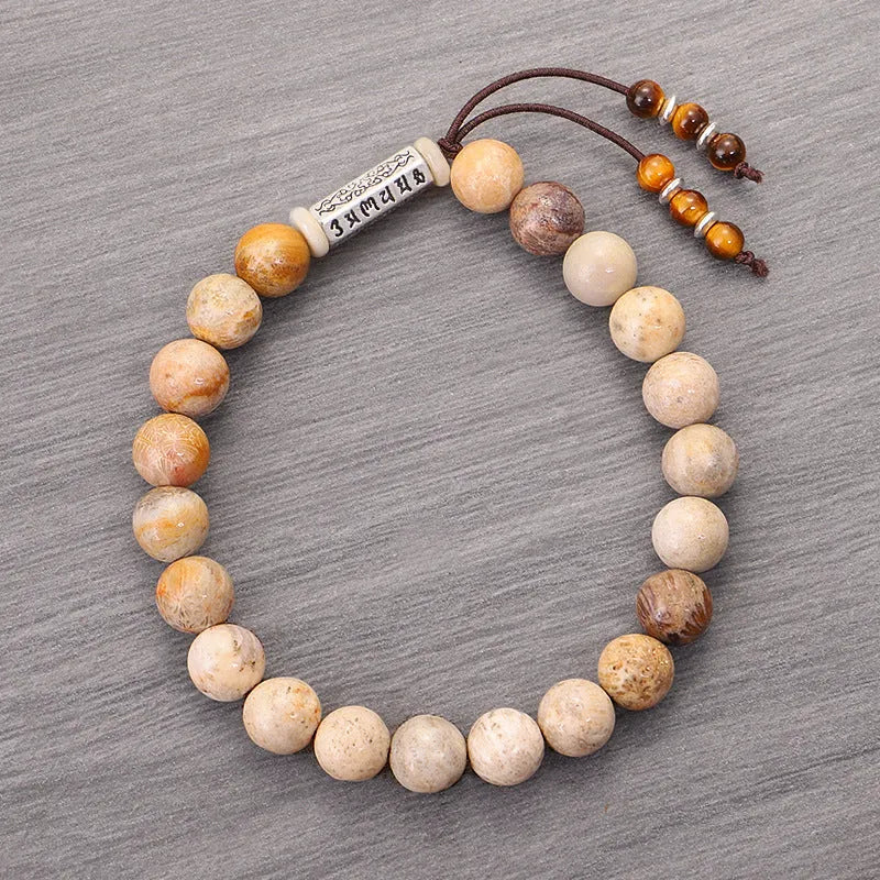 Original design handmade stone bead bracelet in natural wood colour on wrist.