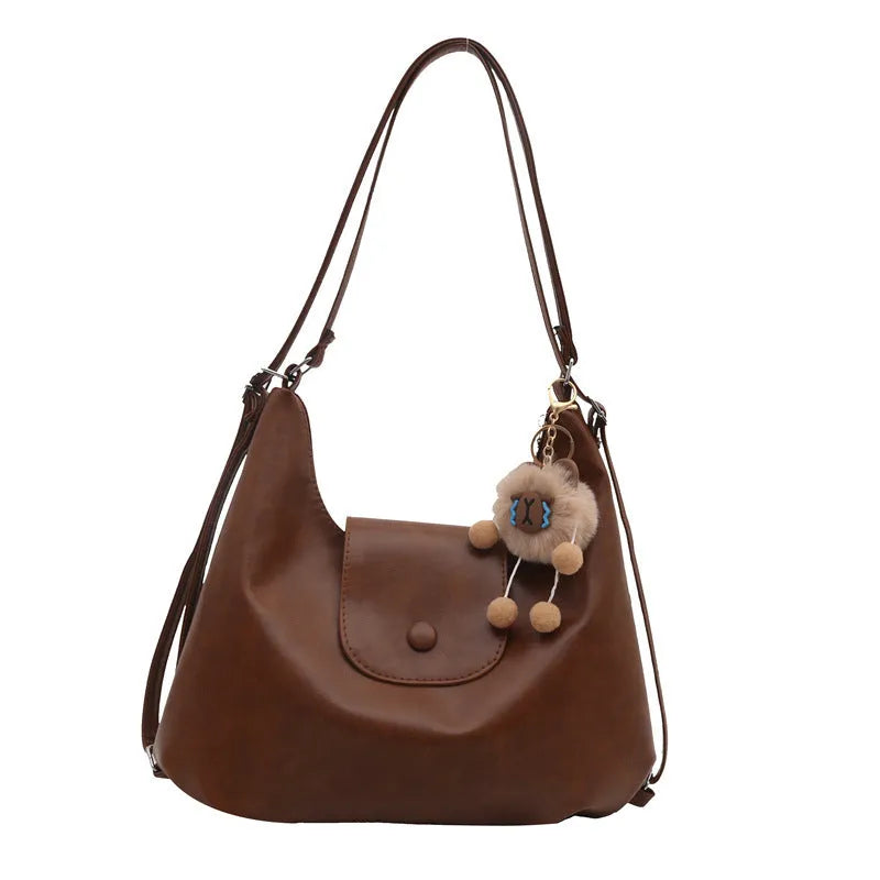 Textured PU leather shoulder bag in horizontal square shape with single strap and internal phone pocket