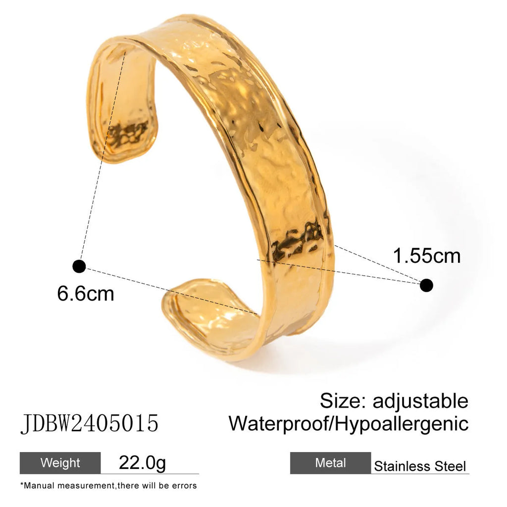 Stainless steel wings motif ring with an open gap design on a plain background