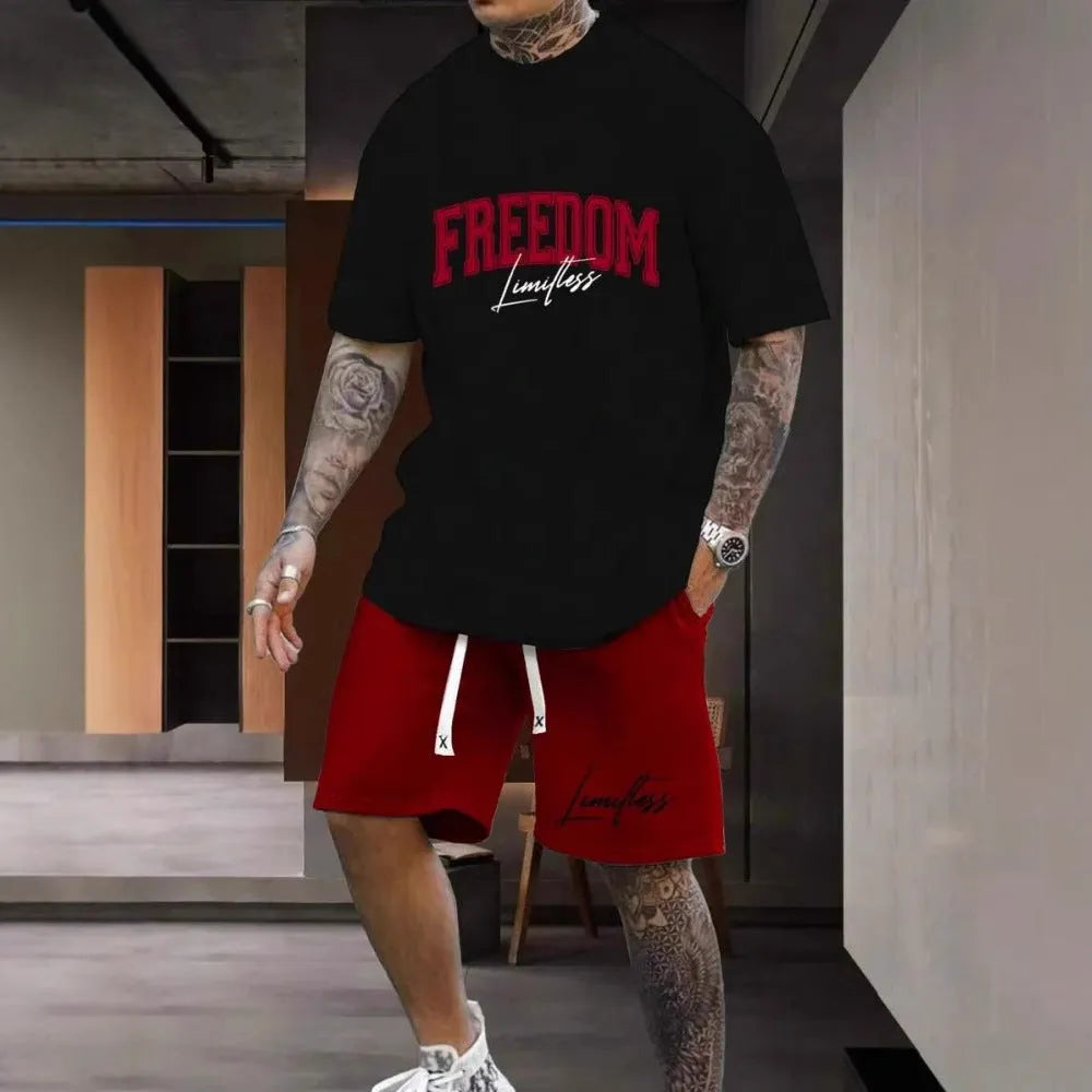 Man wearing a men's short sleeve top and shorts set with a 3D printed letter design, in a sportswear setting.
