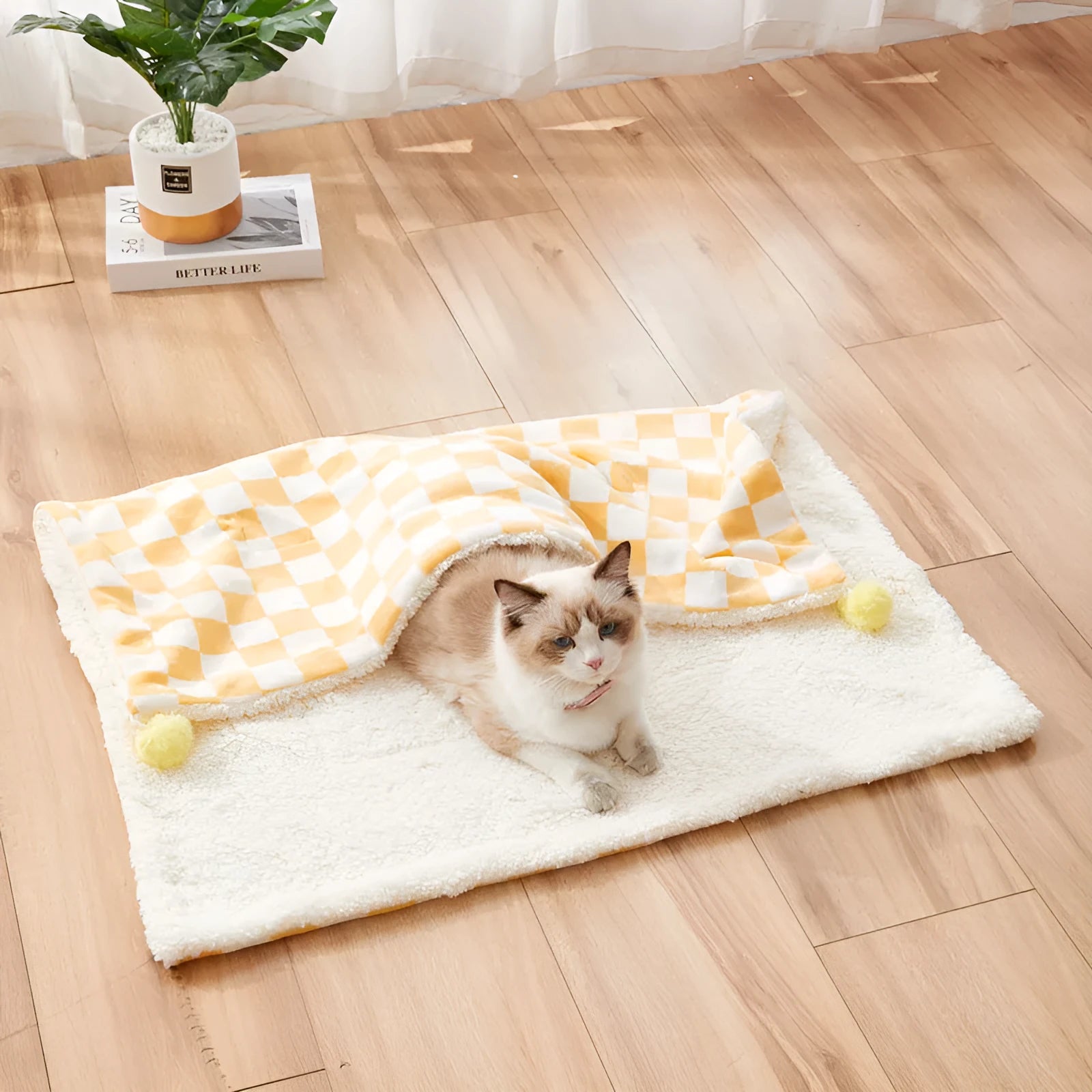 Plaid pattern pet blanket with fur ball decoration in green, pink, or yellow colours on soft fleece material
