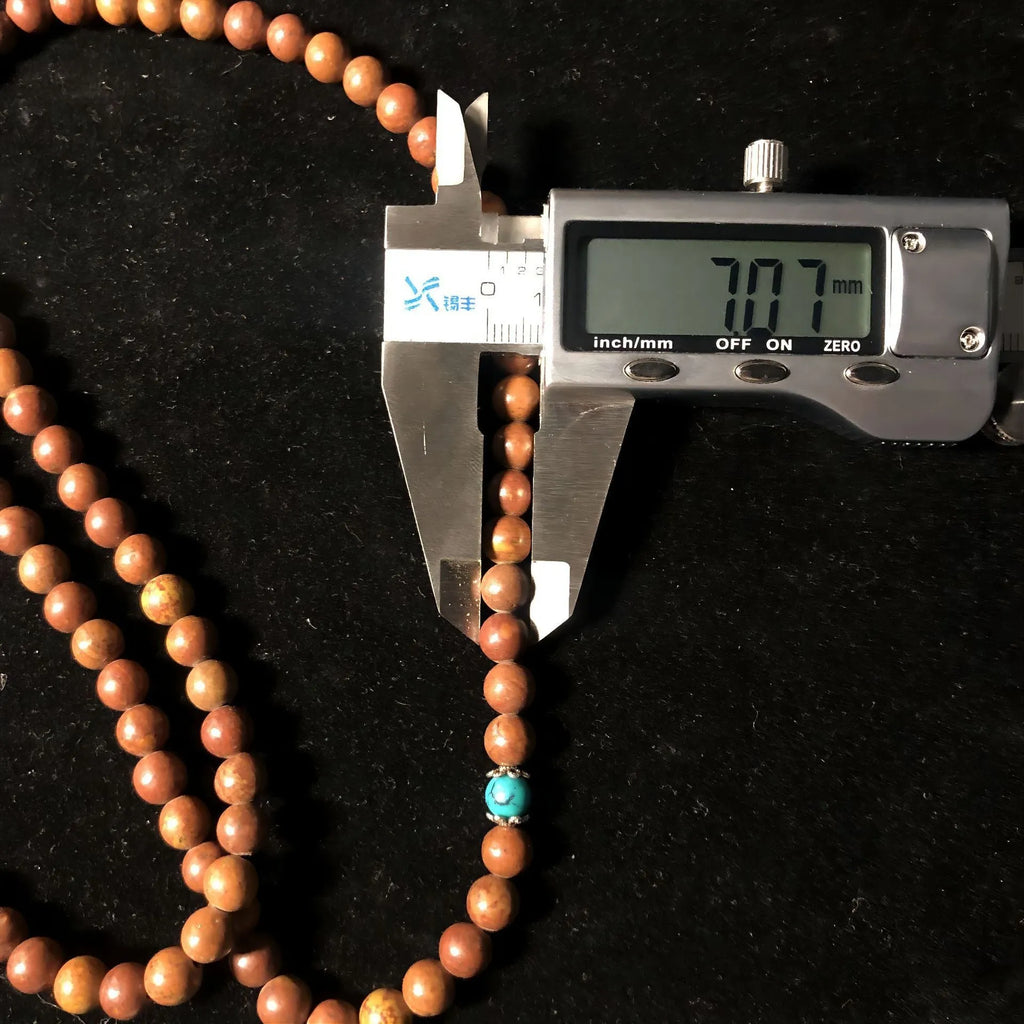 Hand-polished Lvzhu stone bracelet with 108 geometric beads measuring 5-6mm diameter