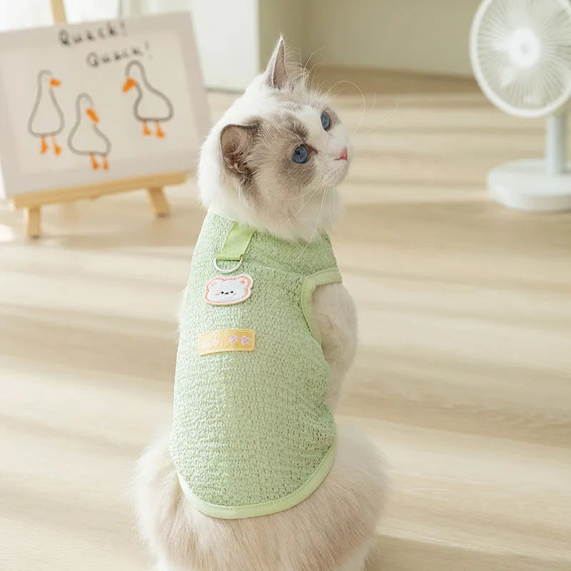 Blue knitted cat clothing with a bear patch, showing hollowed-out breathable design