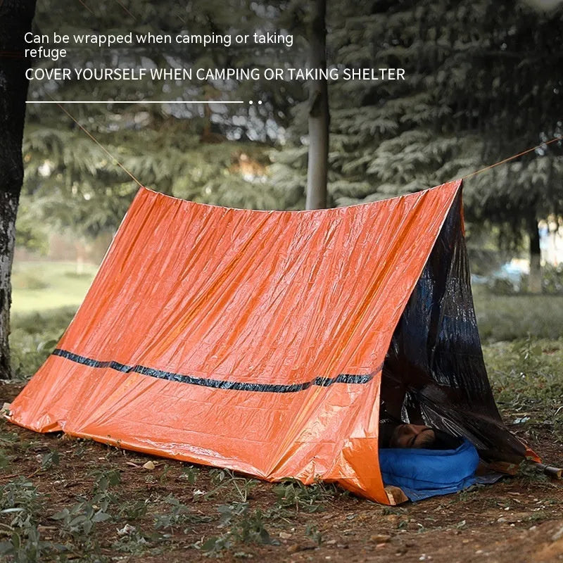 Orange portable disaster relief tent with sleeping bag and emergency blanket for outdoor shelter