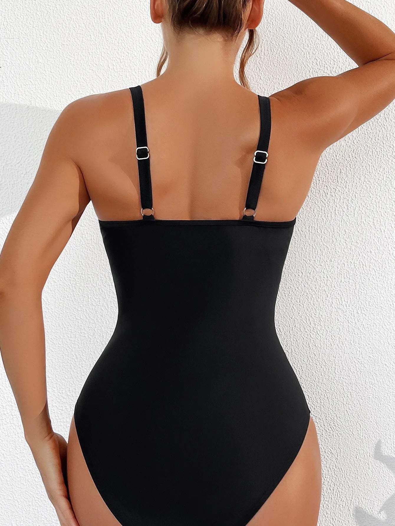 Black women's halter bikini one-piece swimsuit with mesh detailing and briefs style.