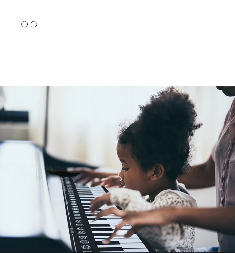 Folding electronic keyboard with 49 keys in pearl white colour, shown both rolled and unrolled