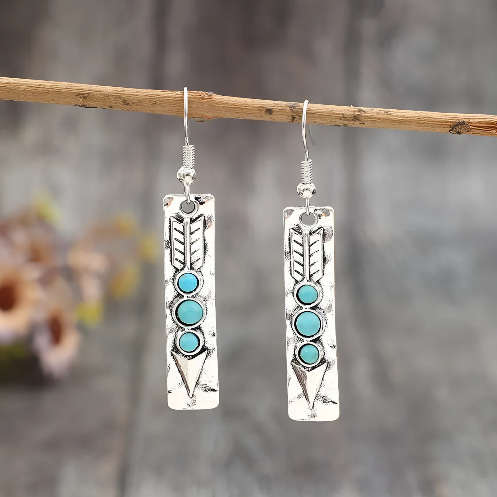 Long geometric silver earrings with turquoise stone accents and retro design