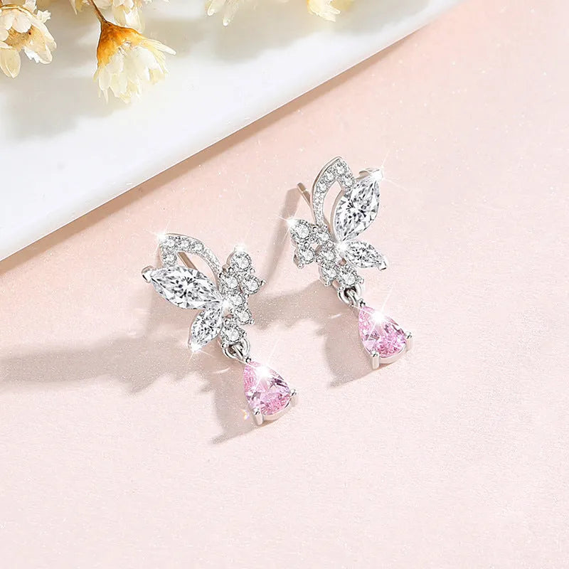 A pair of silver butterfly stud earrings with clear crystal details on a white background.