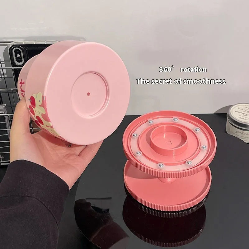 Rotating beige cosmetic brush storage barrel with 18-litre capacity and a separate storage rack on a table.