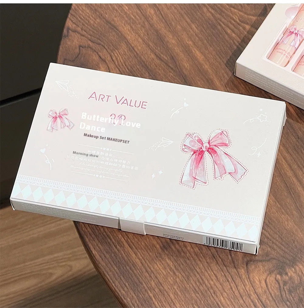 Butterfly Box makeup set with four lip mud tubes, powder blusher compact, and matching necklace on pink background
