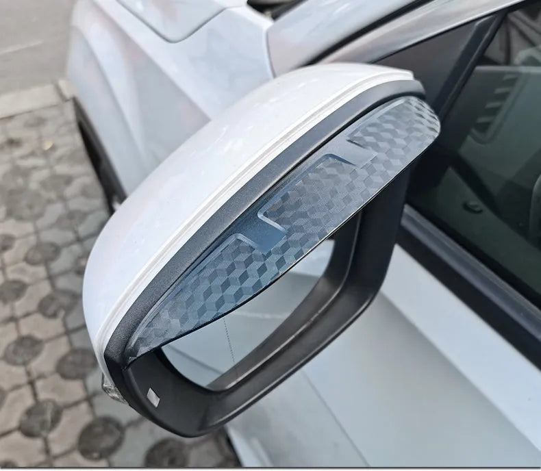 Pair of Mazda reversing mirror rain barrier strips in carbon fibre pattern on a Mazda CX5 side mirror