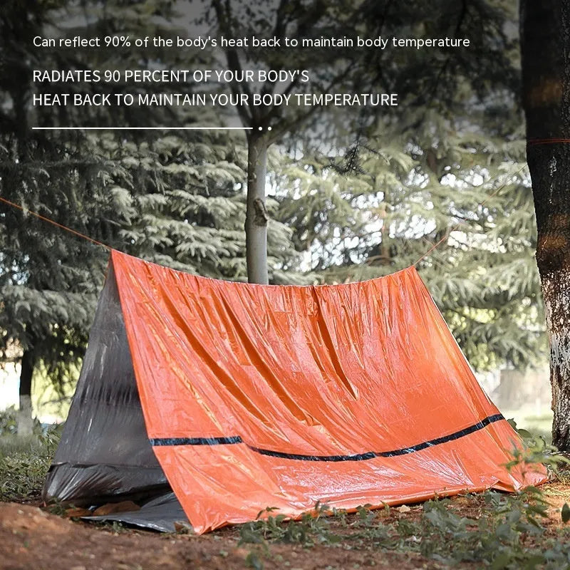 Orange portable disaster relief tent with sleeping bag and emergency blanket for outdoor shelter