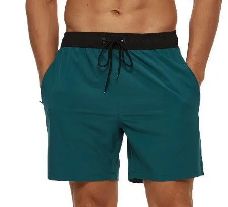 Men's blue athletic shorts with stitching waist detail and zipper pockets for running and fitness