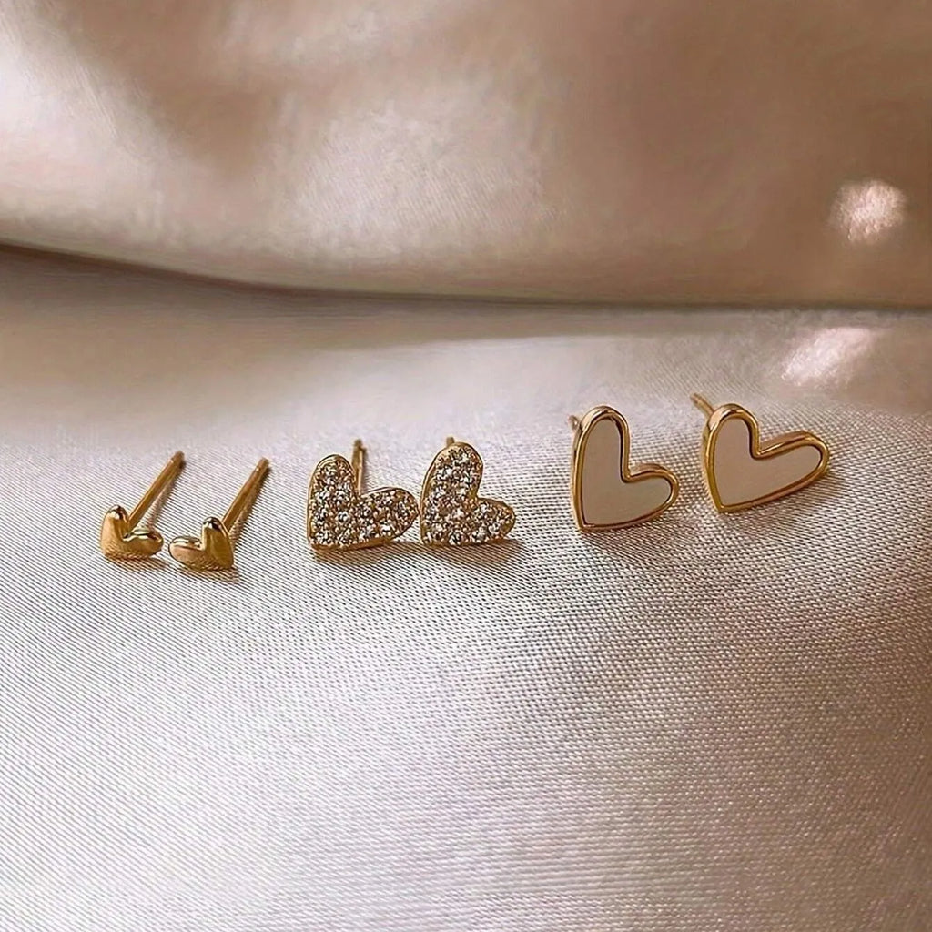 Three pairs of women's heart-shaped alloy earrings in electroplated gold, black, black-white, or pink colours