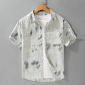 Men's light green floral print cotton cardigan with short sleeves on a hanger