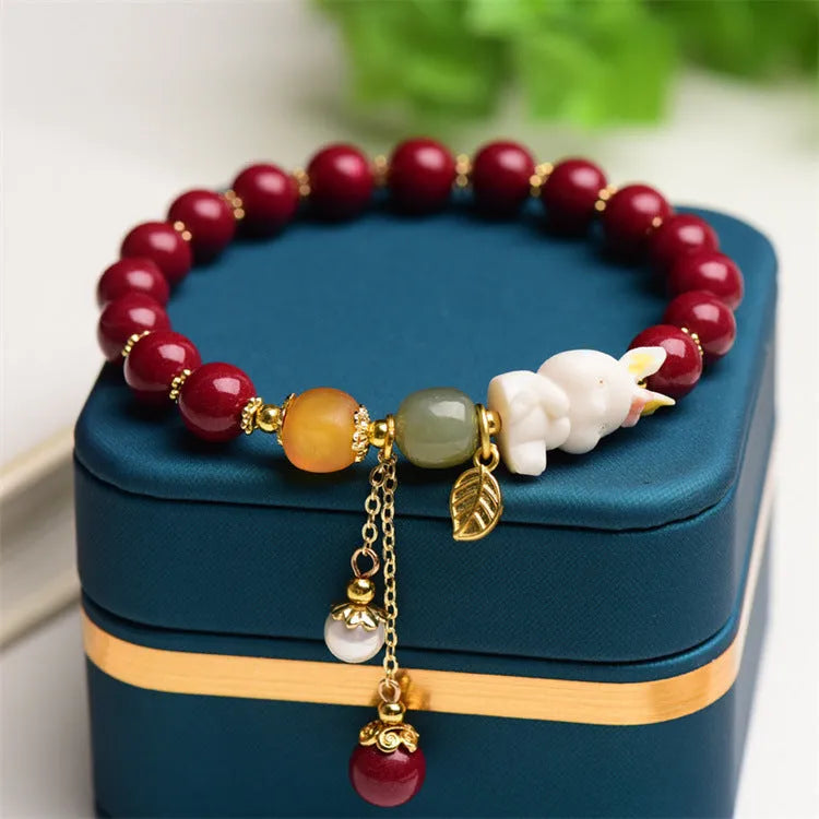 Natural cinnabar bracelet for women in purple-gold sand with rabbit motif, showing 8mm and 10mm bead size options.