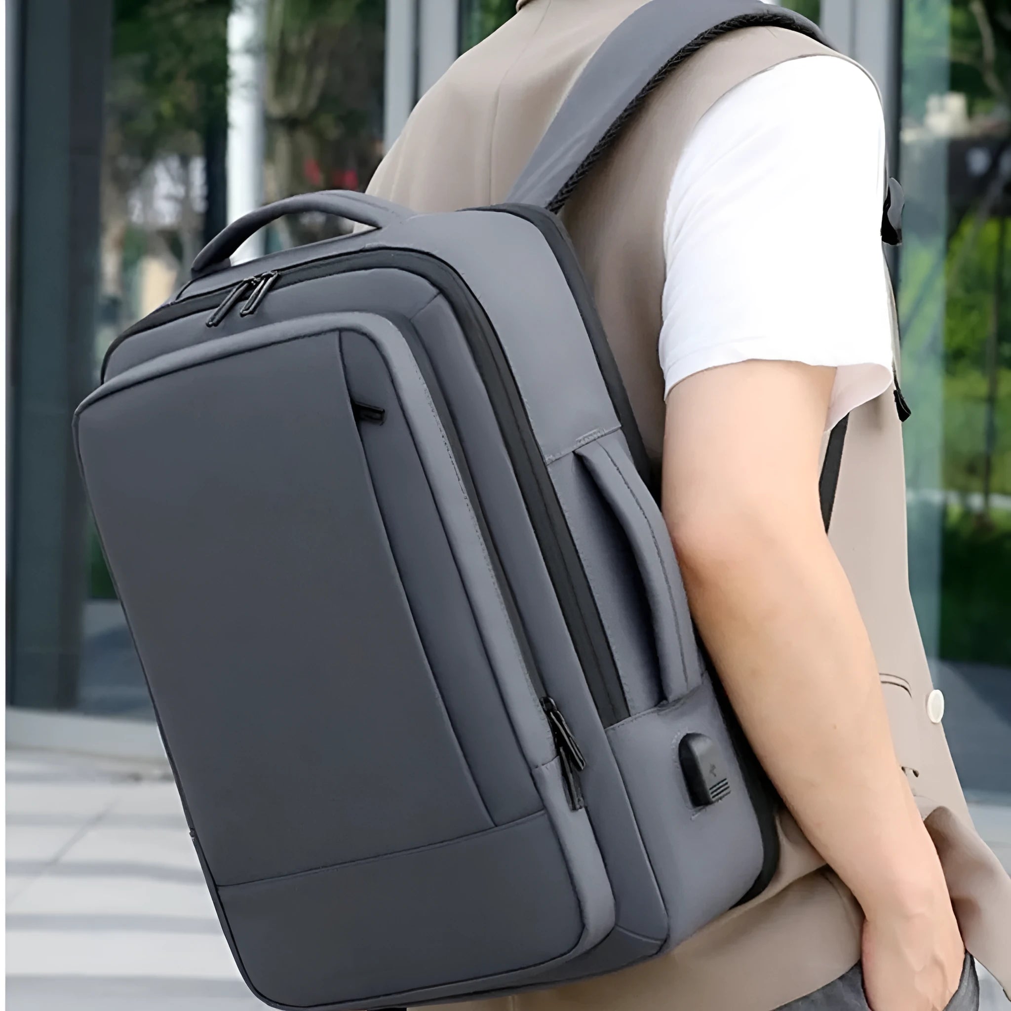 Large black waterproof Oxford cloth backpack with curved shoulder straps on a grey background.