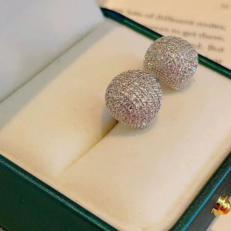 Gold or white geometric drop-shaped clip earrings with spherical bead elements