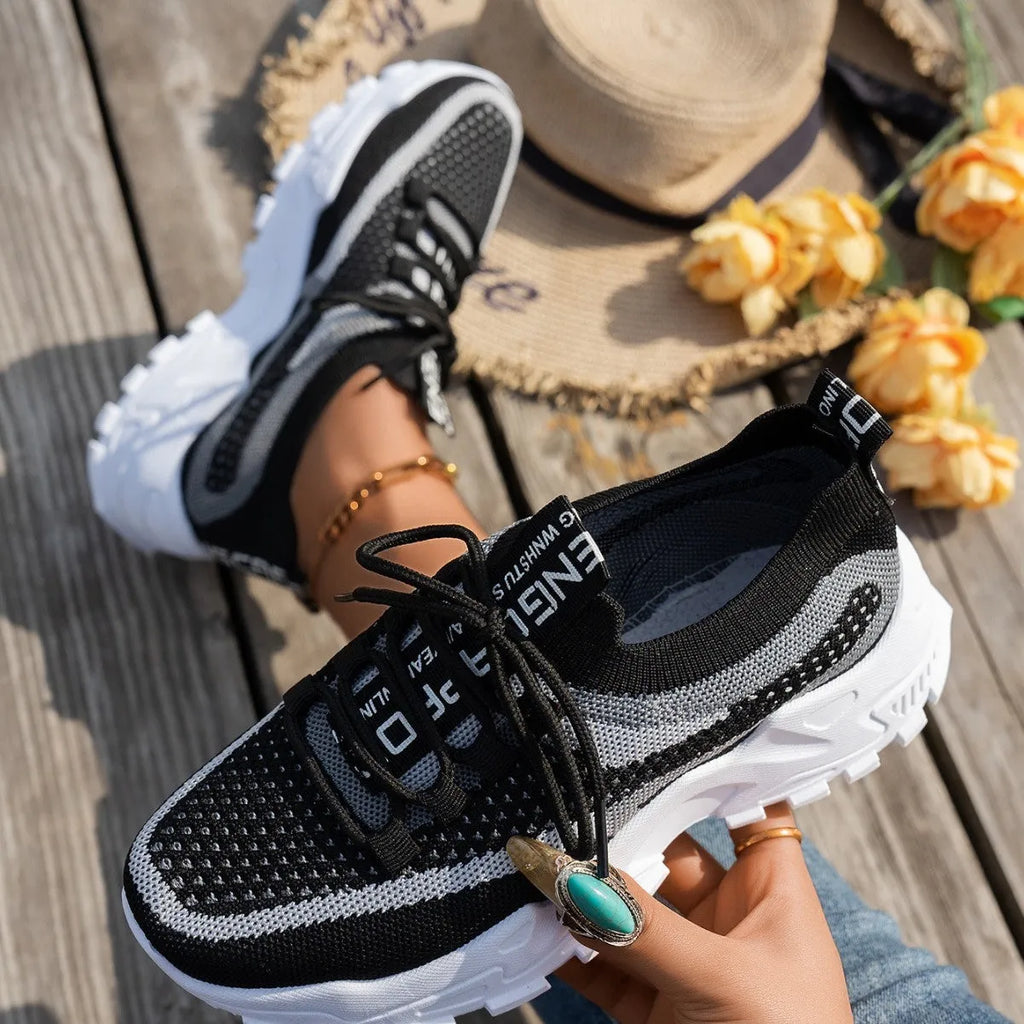 Women's Flyknit mesh lace-up sneakers in a multi-tone colourway with a low rubber sole.