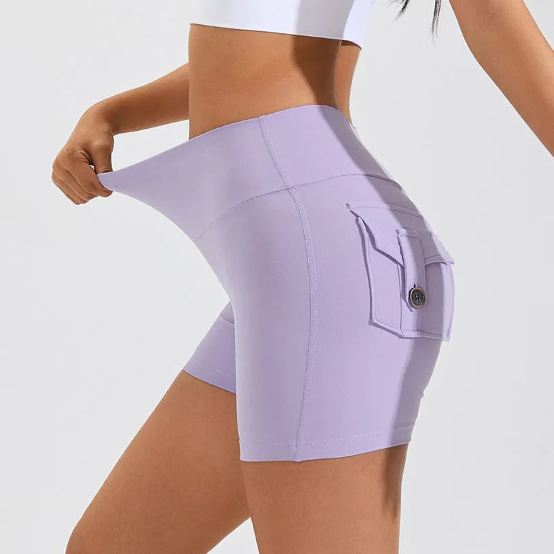 Women's high waist sport shorts in avocado green colour with pockets, on a mannequin.