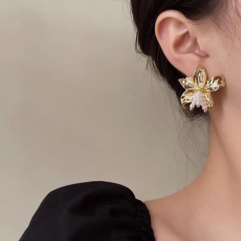 Gold H1795 colour exaggerated pearl flower earrings with metal construction and floral design elements