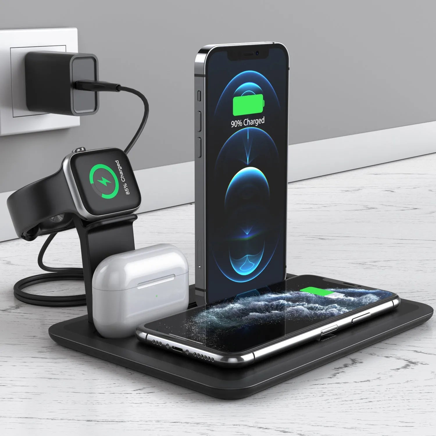 Black wireless charging desk bracket with phone on Qi pad, watch and headphones connected to wired charging ports