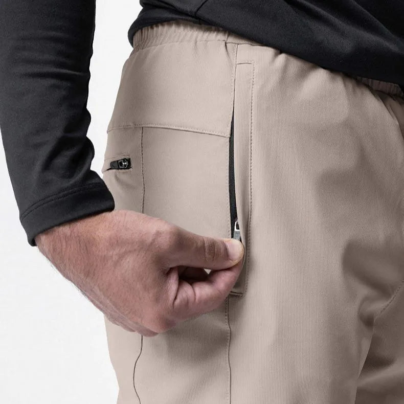 Men's ankle-tied loose fit running pants in a quick-dry fabric, shown in olive green colour.