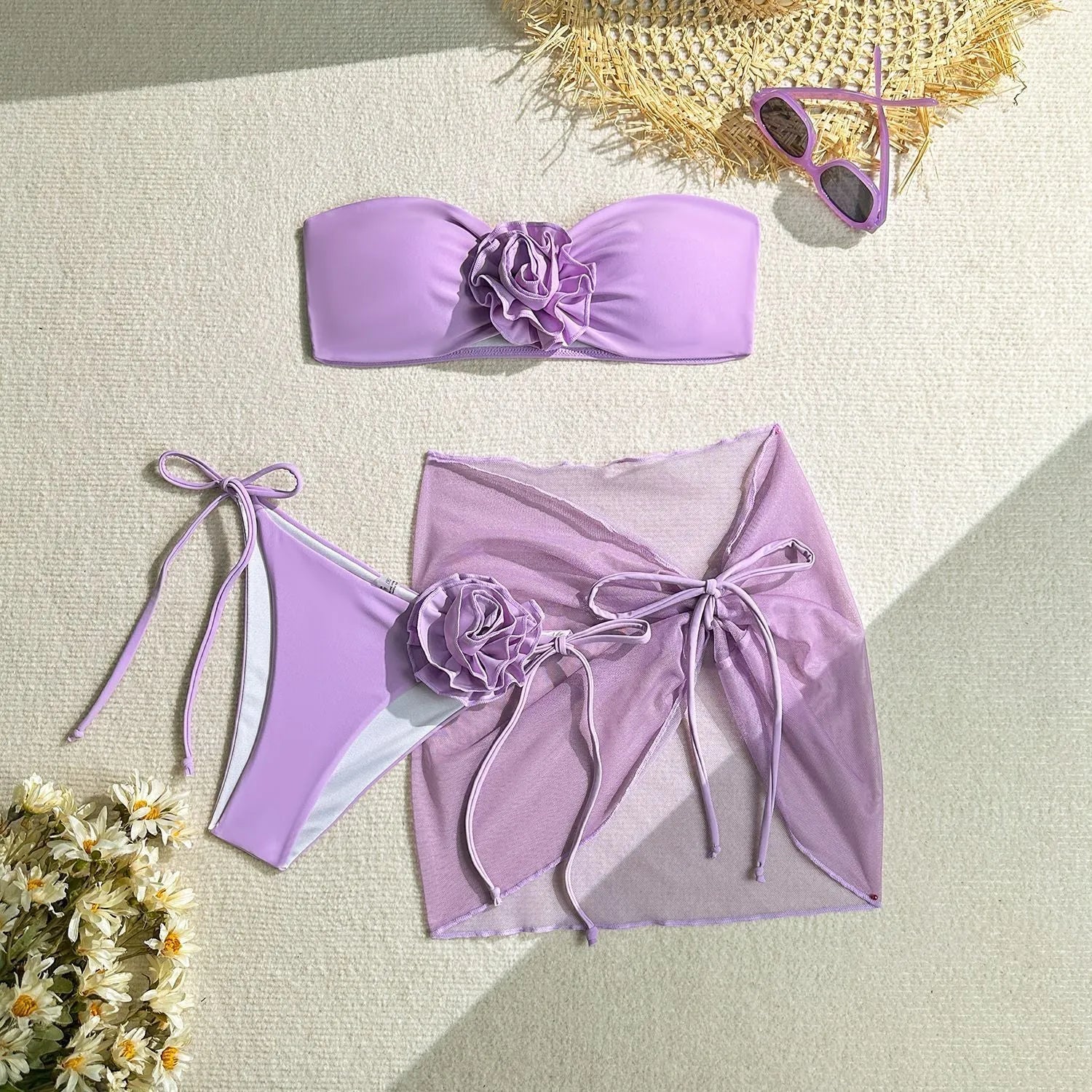 Women's pink tube top swimsuit with a large three-dimensional flower tie detail.